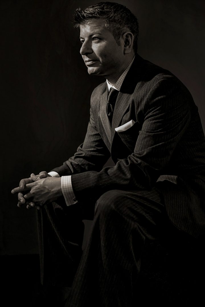 A black business professional poses for a portrait with his tablet and  glasses Stock Photo - Alamy