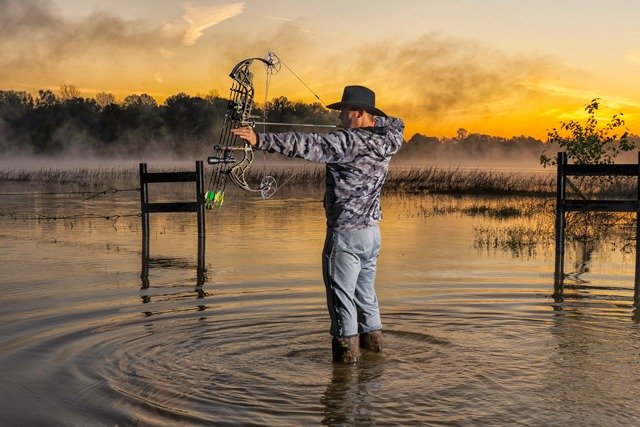 bow hunter in swamp