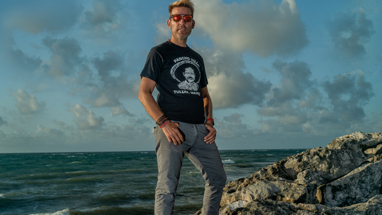 Man sits in meditation pose on sandy beach 4525263 Stock Photo at Vecteezy