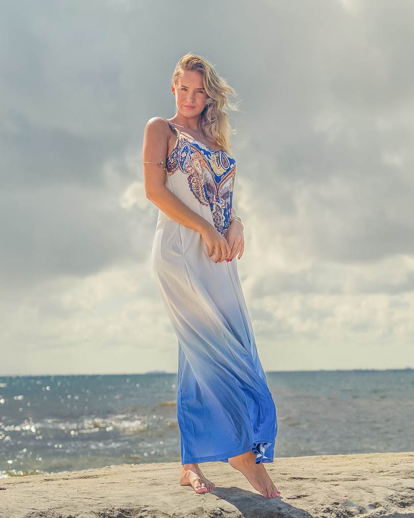 Fashionable Woman Posing On A Beach With Rocks In A Long Dress Stock Photo,  Picture and Royalty Free Image. Image 49211851.