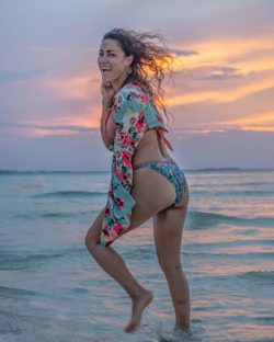 women launging in bikini at sunset in isla mujeres